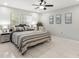 Spacious main bedroom with a ceiling fan, tiled floors, and plenty of natural light at 15 Tads Trl, Oldsmar, FL 34677