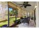 Relaxing screened patio with ceiling fan, comfortable seating, and outdoor views at 15 Tads Trl, Oldsmar, FL 34677