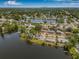 Stunning aerial view of a lakeside home with lush greenery and a serene lake, plus skyline in the distance at 1501 84Th N Ave, St Petersburg, FL 33702