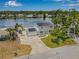 Aerial view of home highlighting its well-maintained lawn, solar panels, and lake access at 1501 84Th N Ave, St Petersburg, FL 33702