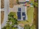 Birds-eye view of the property, displaying its solar panels, and proximity to the water at 1501 84Th N Ave, St Petersburg, FL 33702