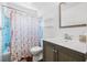Bathroom with a blue shower, floral shower curtain, and traditional vanity at 1501 84Th N Ave, St Petersburg, FL 33702