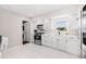 Modern kitchen featuring white cabinets, stainless steel appliances, and a lovely view of the outdoors at 1501 84Th N Ave, St Petersburg, FL 33702