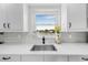 Kitchen sink area with a window view, white countertop, and modern faucet at 1501 84Th N Ave, St Petersburg, FL 33702