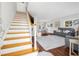 Bright living room with staircase, hardwood floors, a chandelier, a dining table set, and comfortable grey seating at 1501 84Th N Ave, St Petersburg, FL 33702