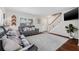 The living room features hardwood floors, a grey leather couch, and an accent rug, creating a cozy and stylish space at 1501 84Th N Ave, St Petersburg, FL 33702
