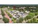 Striking aerial shot of community buildings featuring ample parking and meticulous landscaping with mature trees at 16916 Dorman Rd, Lithia, FL 33547