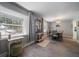 Charming dining area with an abundance of natural light, decor shelving, and updated floors at 1715 Belleair Forest Dr # C, Belleair, FL 33756