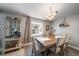 This dining area has a cozy atmosphere, a stylish chandelier, and updated flooring at 1715 Belleair Forest Dr # C, Belleair, FL 33756