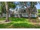 Charming townhome with a well-manicured lawn and mature trees at 1715 Belleair Forest Dr # C, Belleair, FL 33756
