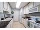 Efficient kitchen with white cabinetry and ample counter space at 1715 Belleair Forest Dr # C, Belleair, FL 33756