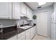 Bright kitchen with white appliances and plenty of counter space at 1715 Belleair Forest Dr # C, Belleair, FL 33756