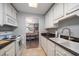 Well-lit kitchen featuring ample counter space and a view into the dining area at 1715 Belleair Forest Dr # C, Belleair, FL 33756