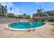 Inviting community pool with lounge chairs and festive decorations at 1715 Belleair Forest Dr # C, Belleair, FL 33756