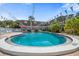 Inviting community pool with lounge chairs and a well-maintained surrounding area at 1715 Belleair Forest Dr # C, Belleair, FL 33756