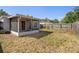 Backyard view with screened-in patio, wood fence and grassy area at 18106 Lembrecht Way, Tampa, FL 33647