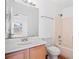 Bathroom with tiled shower over tub, vanity, light fixture and a large mirror at 18106 Lembrecht Way, Tampa, FL 33647