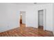 Bedroom offers hardwood floors, white walls, and access to closet and adjacent bath at 18106 Lembrecht Way, Tampa, FL 33647