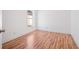 Cozy bedroom featuring sleek hardwood floors, a bright window, and fresh paint at 18106 Lembrecht Way, Tampa, FL 33647