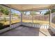 Screened patio looking out onto yard with wood fence and mature trees in background at 18106 Lembrecht Way, Tampa, FL 33647