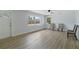 A bright and open living area featuring wood-look flooring, neutral color scheme and natural light at 1857 Siesta Dr, Sarasota, FL 34239