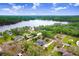 Beautiful aerial view of a home surrounded by trees, with lake views in the distance at 18929 Crescent Rd, Odessa, FL 33556