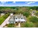 Breathtaking aerial view showcases this beautiful two-story home, surrounded by lush landscaping, and tree coverage at 18929 Crescent Rd, Odessa, FL 33556