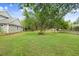 Expansive backyard with mature trees and lush green lawn, perfect for outdoor activities and relaxation at 18929 Crescent Rd, Odessa, FL 33556