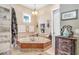 Serene bathroom featuring a soaking tub with jets, vanity, updated fixtures and decor at 18929 Crescent Rd, Odessa, FL 33556