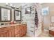 Beautiful bathroom boasting granite countertops, unique mirrors, shiplap accent wall, and bright natural light at 18929 Crescent Rd, Odessa, FL 33556