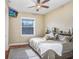Bedroom with dark wooden floors, a large window, ceiling fan and a calming decor at 18929 Crescent Rd, Odessa, FL 33556