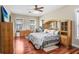 Bedroom featuring wood floors, custom closets, natural light, and a queen size bed at 18929 Crescent Rd, Odessa, FL 33556