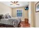 Comfortable bedroom with wooden floors, ceiling fan, plus a window with bright natural light at 18929 Crescent Rd, Odessa, FL 33556