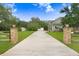 Long driveway leading to a home with well-kept grounds and extra garage space at 18929 Crescent Rd, Odessa, FL 33556