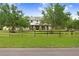 Beautiful two-story home with a charming front porch and sprawling green lawn, framed by mature trees at 18929 Crescent Rd, Odessa, FL 33556
