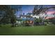 Stunning home with a lush lawn, screened in porch and ambient lighting, perfect for enjoying outdoor living at 18929 Crescent Rd, Odessa, FL 33556