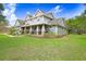 Spacious home with lush landscaping, a covered porch, and a well-manicured lawn at 18929 Crescent Rd, Odessa, FL 33556