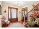Elegant foyer featuring hardwood floors, a decorative rug, and a staircase with ornate details at 18929 Crescent Rd, Odessa, FL 33556