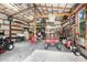 Spacious garage interior with organized storage, including a golf cart and other tools and equipment at 18929 Crescent Rd, Odessa, FL 33556