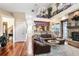 Spacious living room with hardwood floors, a large sectional sofa, and a view of the upstairs loft at 18929 Crescent Rd, Odessa, FL 33556