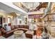 Open living area with high ceilings, a stone fireplace, and a glimpse into the adjoining kitchen and dining area at 18929 Crescent Rd, Odessa, FL 33556