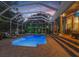 Inviting pool area featuring a screened enclosure, lounge chairs, and easy access to the home's living area at 18929 Crescent Rd, Odessa, FL 33556