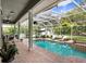 Stunning screened-in pool area with lounge chairs and lush landscaping at 18929 Crescent Rd, Odessa, FL 33556