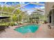 Gorgeous screened-in pool with an integrated spa and plenty of seating at 18929 Crescent Rd, Odessa, FL 33556