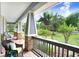 Relaxing porch with wicker furniture and hanging plants, offering a peaceful outdoor retreat at 18929 Crescent Rd, Odessa, FL 33556