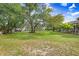 Expansive and well-maintained yard with mature trees providing a serene and private setting at 18929 Crescent Rd, Odessa, FL 33556