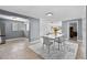 Bright dining area with ample space, sleek white furniture, and tiled flooring at 2026 Cocoanut Ave, Sarasota, FL 34234