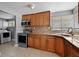 Kitchen with stainless steel appliances and natural wood cabinets at 2026 Cocoanut Ave, Sarasota, FL 34234