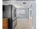 A glimpse of a kitchen with stainless steel refrigerator and light-filled dining area at 2026 Cocoanut Ave, Sarasota, FL 34234