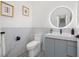 Modern half bathroom features patterned tile flooring, updated sink and marble accent wall at 2104 4Th S St, St Petersburg, FL 33705